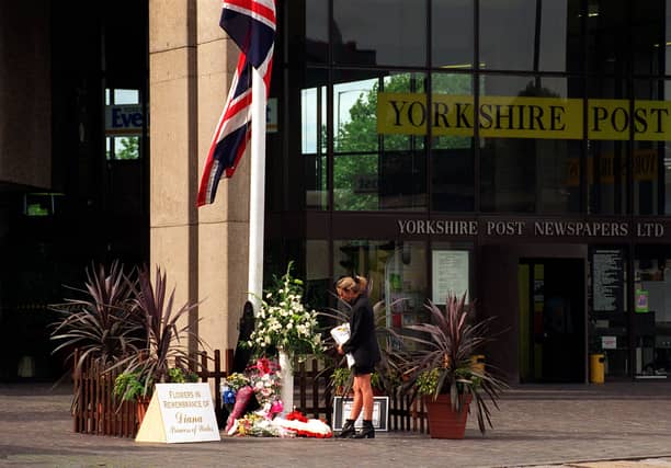 A member of the public lays some flowers outside the Yorkshire Evening Post in memory of Diana Princess of Wales.