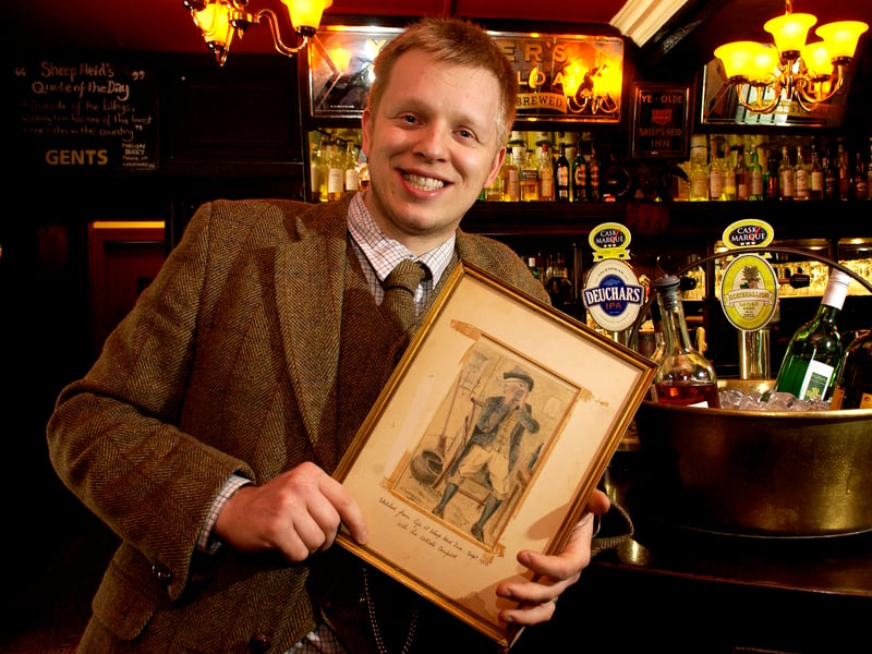 Douglas Johnston-Smith, landlord of the Sheep's Heid, with the picture painted in the pub that he found on the internet, in April 2007