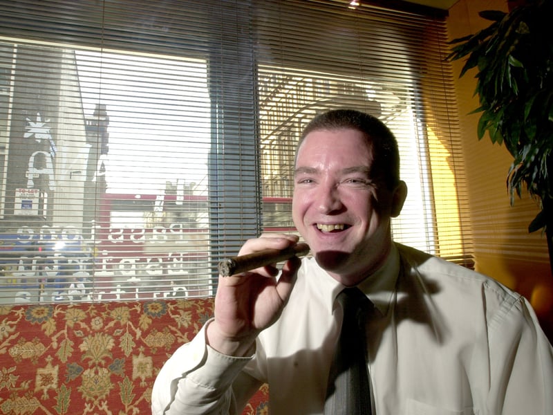 Manager Andrew Young smoking a Havana cigar in the Havana Bar, on Glasgow's Hope Street, in March  2001