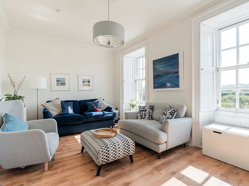 A spiral staircase leads to the first floor where the south-facing sitting room can be found, affording magnificent open views and featuring an open fire and working shutters. This room offers an elegant yet welcoming space.