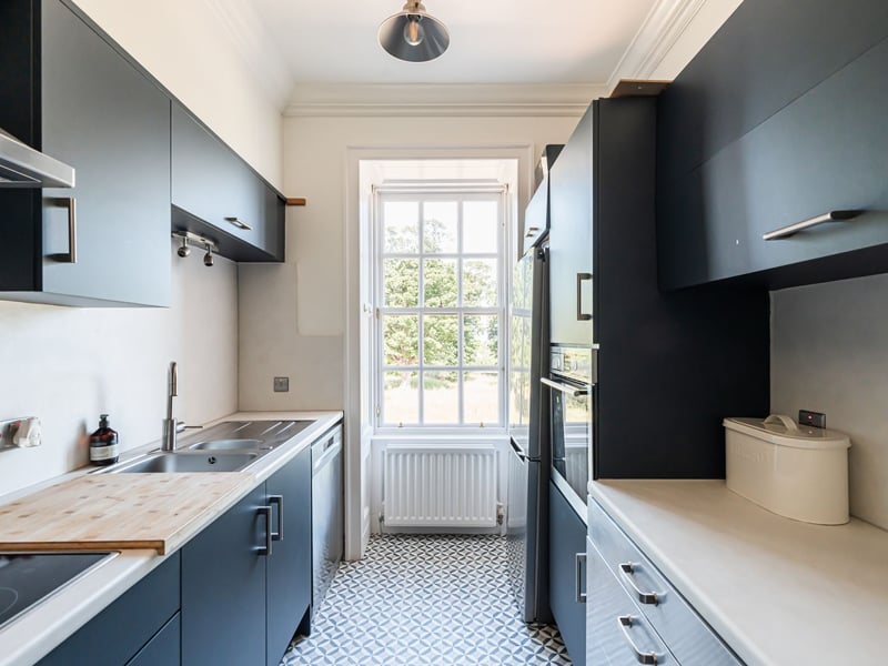 The contemporary kitchen, which also enjoys incredible open views, is fitted with a range of wall and base units with built-in hob with hood above, separate electric oven with further appliances included in the sale.