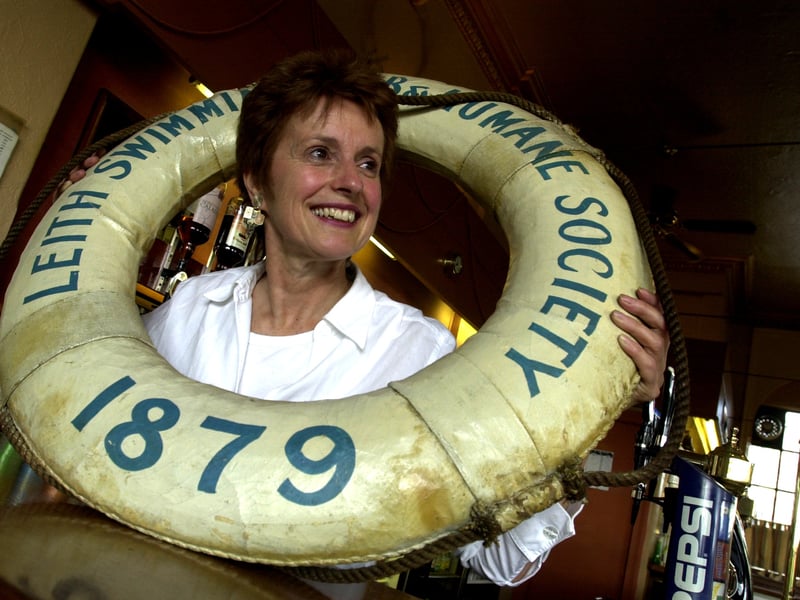 Linda Forrester, landlady of the Junction Bridge bar, with a Leith Swimming Club lifebuoy in 2002. She was planning to donate it to the club when she gave up the pub to run a coffee shop in Portobello.