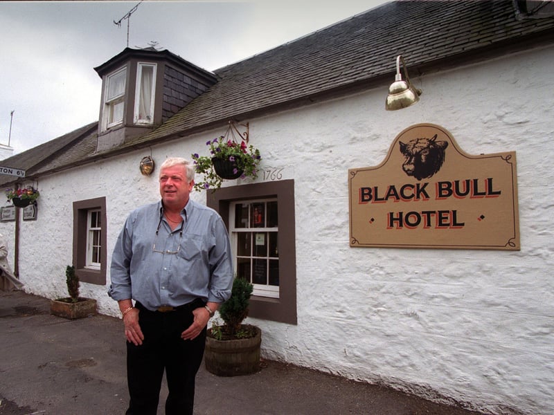 Landlord Kenny Gibson outside the Black Bull Hotel, on Main Street, Straiton, Ayrshire, in 1999. The Black Bull was Benny's Bar in the film 'The Match'.