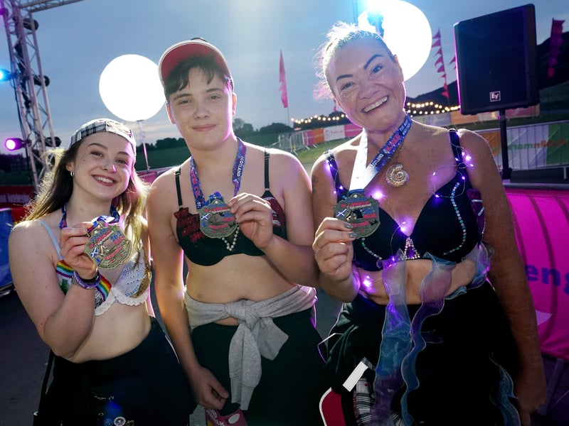 Three walkers posing with their medals after completing the challenge 