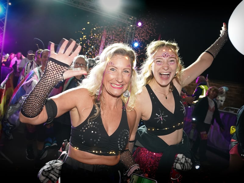 Kitted out with fishnet arm sleeves, face gems and sequins, these walkers capture the party atmosphere of the annual event 