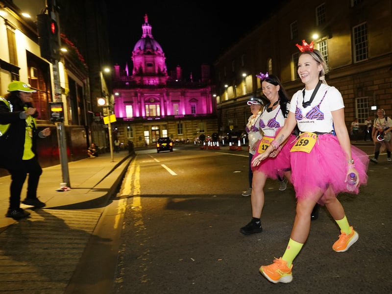 Participants in fancy dress toured some of Edinburgh's most iconic buildings, which were lit up in pink for the event 