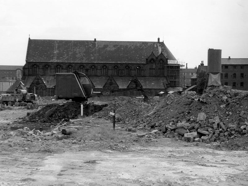 View over land, in the process of being cleared, to St. Patrick's Roman Catholic Church between Rider Street and New York Road. Eventually, Agnes Stewart C. of E. High School was to be built on this sie. On the far right is the Parochial Hall. In the background, left, part of Marsh Lane Goods Station can be seen. Pictured in July 1964.