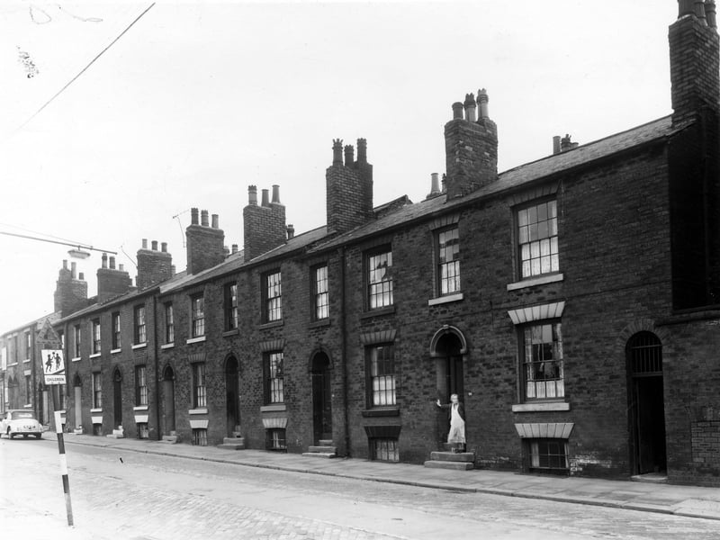 A section of Beckett Street in May 1960, number 78 on the left is marked by the triangle at the top of the school warning sign. Moving right the numbers follow in descending order to 66, where a woman stands in the doorway. The street was named after the Beckett family, two fields belonging to William Beckett MP were purchased to create Beckett Street Cemetery in 1843. The first burial there took place in August 1845.