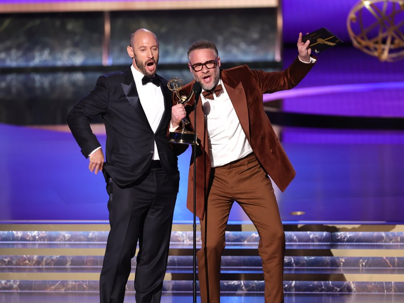 Evan Goldberg and Seth Rogen accept the Outstanding Directing For a Comedy Series award for "The Studio" onstage during the 77th Primetime Emmy Awards.
