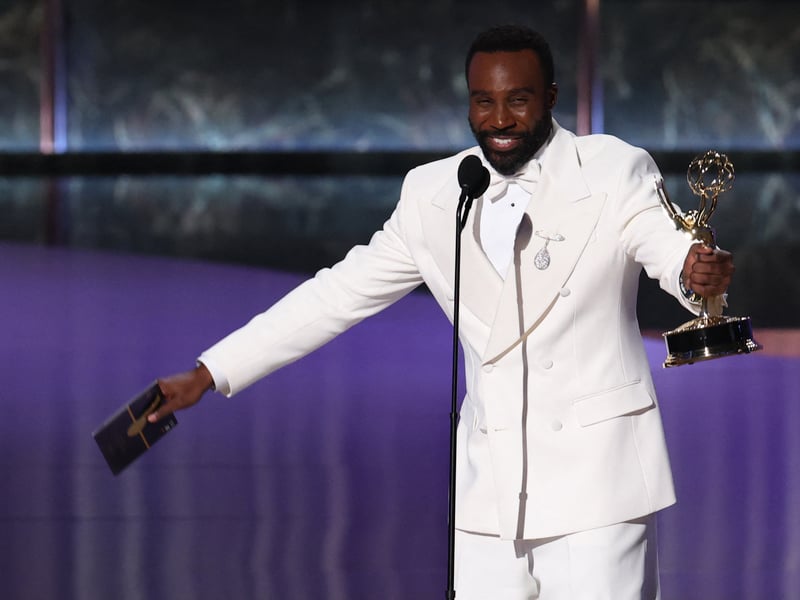 US actor Tramell Tillman accepts the award for Outstanding Supporting Actor in a Drama Series for "Severance" onstage during the 77th Primetime Emmy Awards.