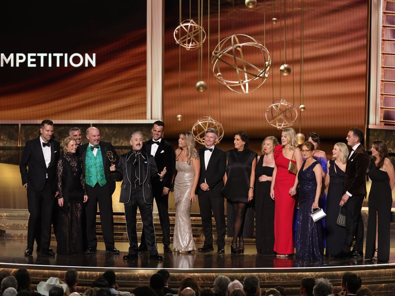 Alan Cumming with cast and crew accept the Outstanding Reality Competition Program award for "The Traitors" onstage during the 77th Primetime Emmy Awards.