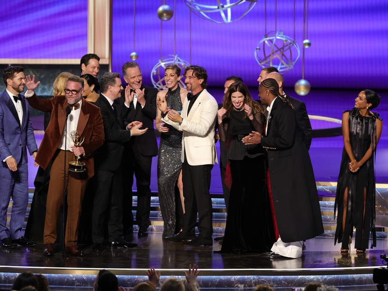 Cast and crew including Peter Huyck, Ike Barinholtz, Seth Rogen, Chase Sui Wonders, Alex Gregory, Chase Sui Wonders, James Weaver, Keyla Monterroso Mejia, Kathryn Hahn, Josh Fagen, Dewayne Perkins, Evan Goldberg, and Frida Perez accept the Outstanding Comedy Series award for "The Studio" onstage during the 77th Primetime Emmy Awards.