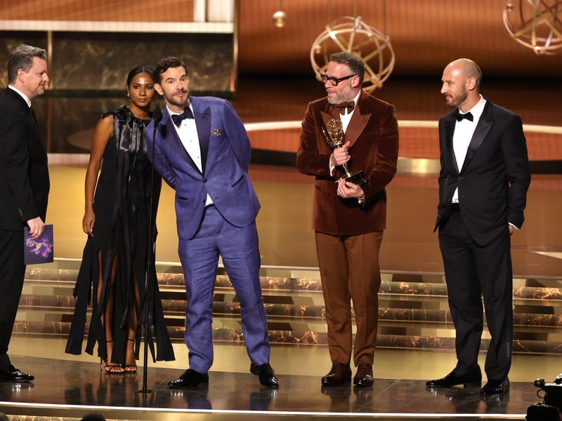 Alex Gregory, Frida Perez, Peter Huyck, Seth Rogen and Evan Goldberg accept the Outstanding Writing for a Comedy Series award for "The Studio" onstage during the 77th Primetime Emmy Awards.
