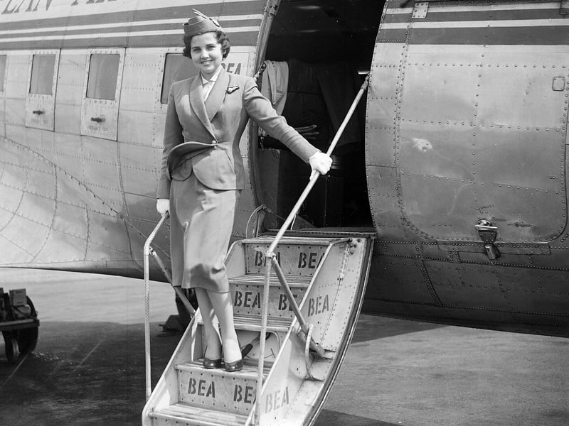 Jill Morgan, an air hostess with BEA (British European Airways) stands on the steps to a plane at Turnhouse airport.