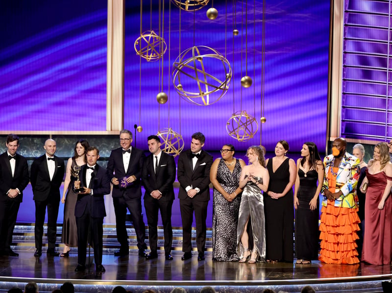 Writers from "Last Week Tonight with John Oliver" such Daniel O'Brien (speaking, holding trophy) and John Oliver accept the Outstanding Writing for a Variety Series award for "Last Week Tonight with John Oliver" speaks onstage during the 77th Primetime Emmy Awards.