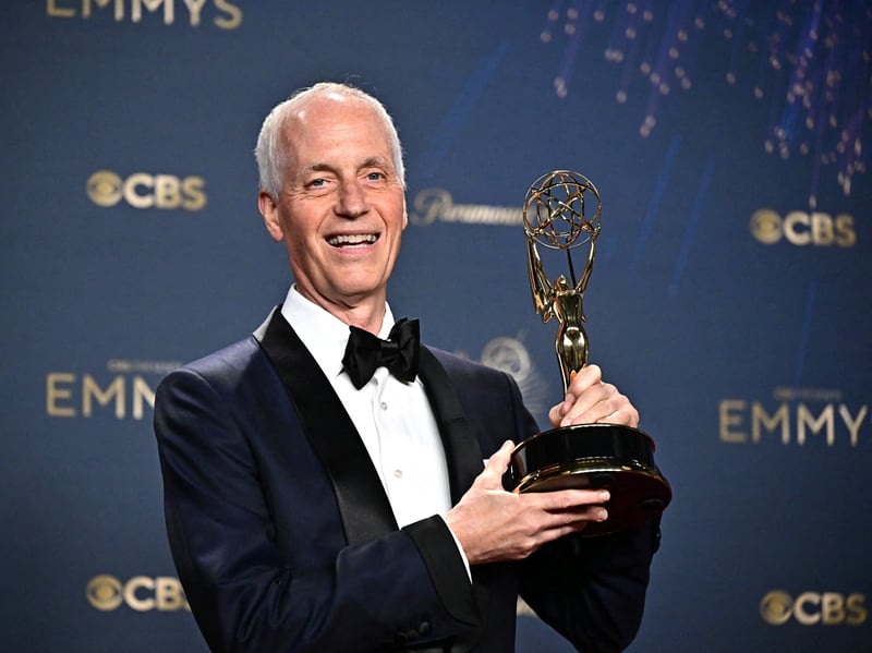 US screenwriter Dan Gilroy poses in the press room with the award for Outstanding Writing for a Drama Series for "Andor," during the 77th Primetime Emmy Awards.