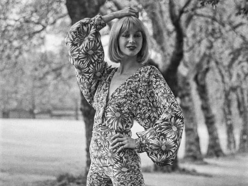 A model wearing a flared trouser suit in a floral fabric, in May 1972