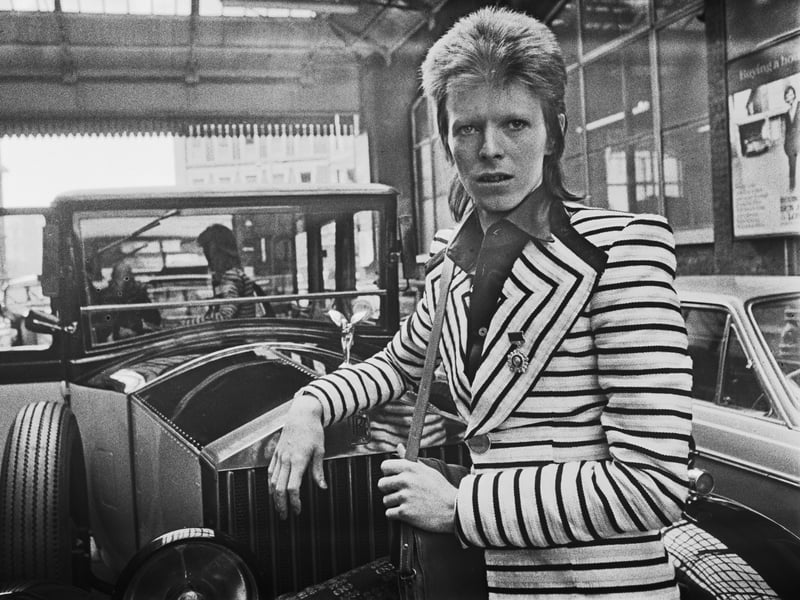 One of pop's snazziest dressers, David Bowie, pictured during his Ziggy Stardust tour in 1973, wearing a striped hack with big lapels