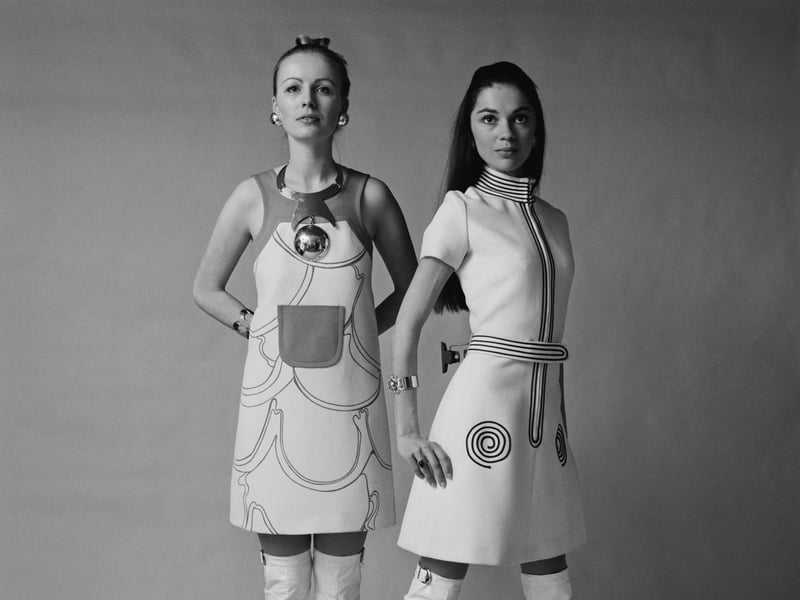 Geometric patterns were popular in the 70s. These models are pictured in 1970, sporting geometric designs on sleeveless short dresses, with white go-go boots