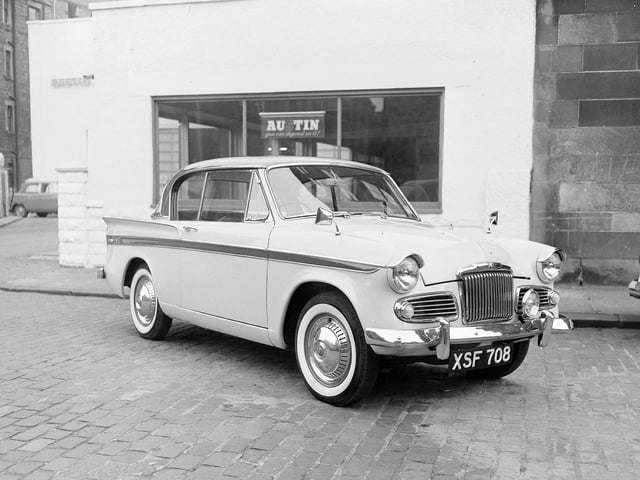 A brand new 1960 Sunbeam Rapier sitting outside a car showroom in Scotland.
