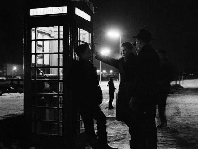 Teenagers haging around outside a telephone box in Kirkcaldy in 1960.