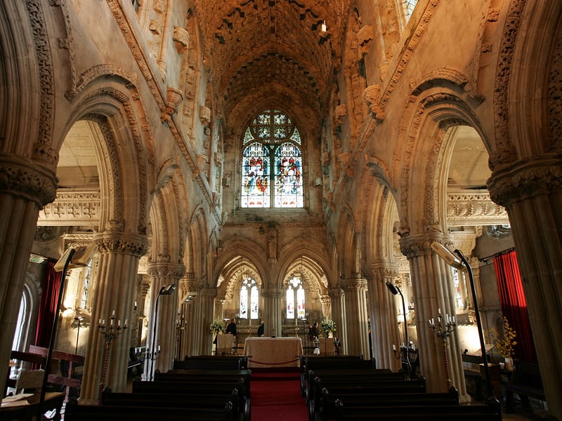 Rosslyn Chapel, also known as the Collegiate Chapel of Saint Matthew, is a 15th-century Episcopal chapel located in the village of Roslin in Midlothian. Rosslyn Chapel's construction began in 1446 when it was founded by Sir William St Clair, though it remained incomplete at the time of his death in 1484. The chapel is built in a Gothic style known for its intricate and mysterious symbolism in its ornate stonework.