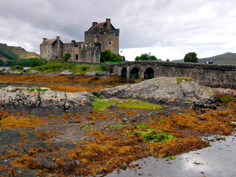 Eilean Donan Castle is believed to be one of Scotland's most beautiful and photographed castles. It is also featured on many shortbread tins. Eilean Donan Castle was built in 1220 by Alexander II of Scotland. A stronghold of the MacKenzie and MacRae clans, it is said to have been one of the refuges of Robert the Bruce when he was on the run from the English. The castle was destroyed by English naval bombardment in 1719 but was restored in 1932.