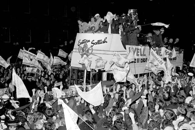 Hibs fans celebrate their team's 1972 League Cup win as the team show off the trophy from an open top bus.