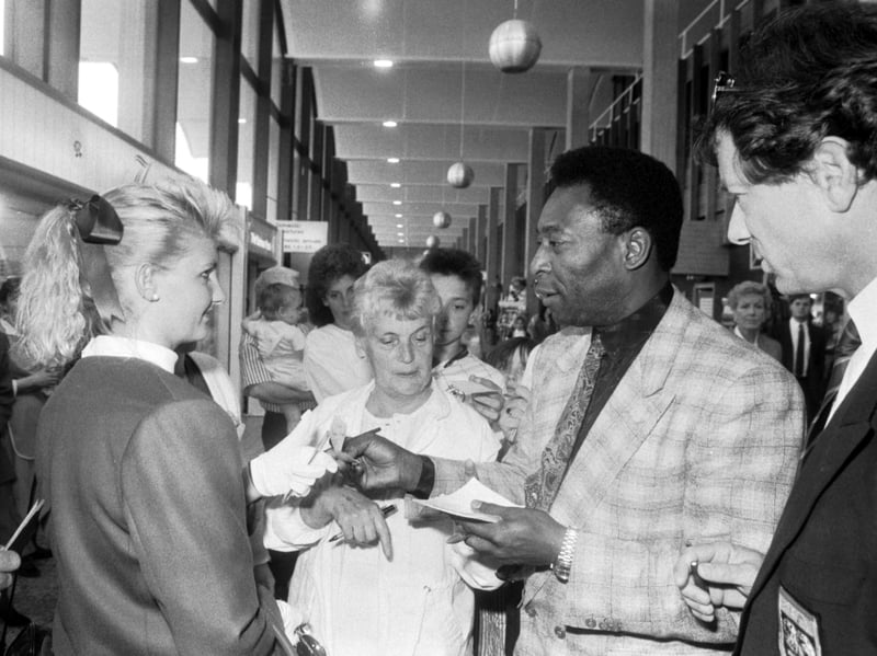 Brazilian football legend Pele signs autographs at Glasgow airport in June 1989