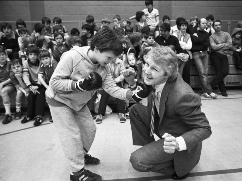 Former world lightweight champion boxer Jim Watt takes one on the chin from a small boy at the opening of Grangemouth's Easter Cavalcade in April 1983