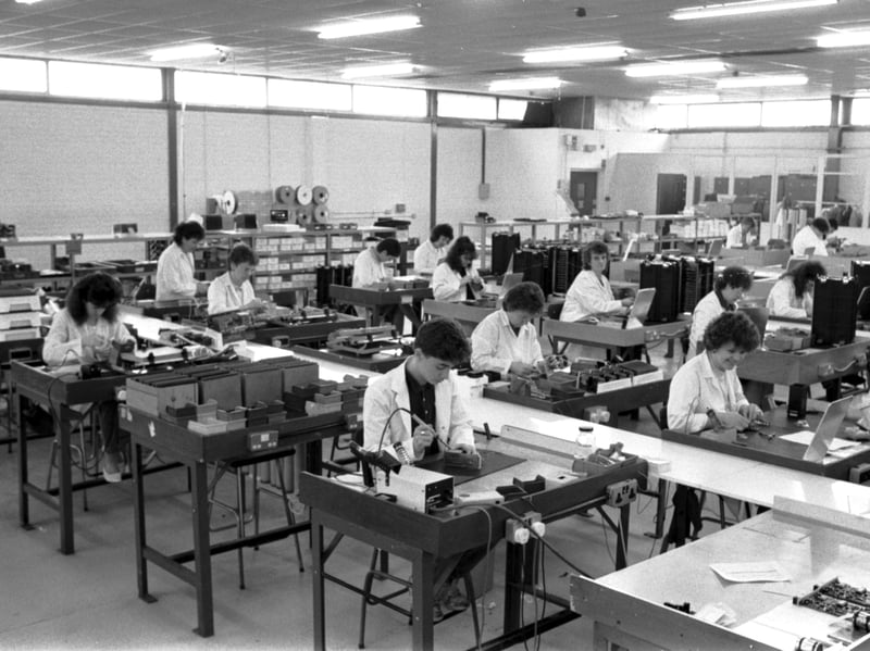People working with soldering irons on the shop floor of Highland Electronics' factory, on the Hillend industrial estate, Fife, in April 1989