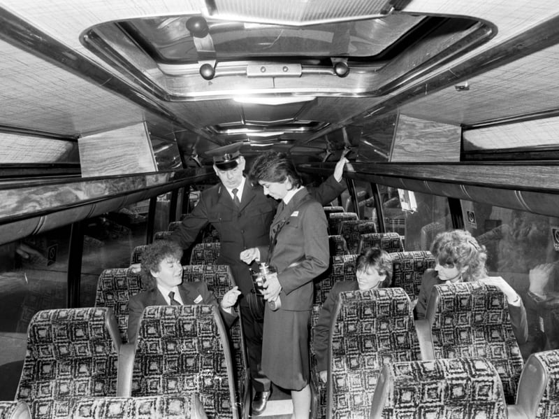Bus conductors training in July 1988. Anita Parsons practises on her colleagues, watched by an inspector.