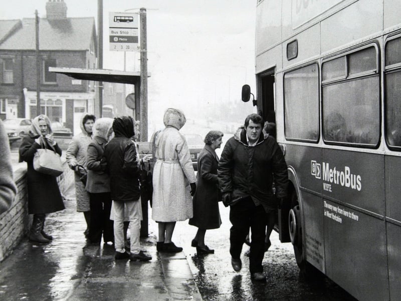 Passengers queue to board a bus in April 1983
