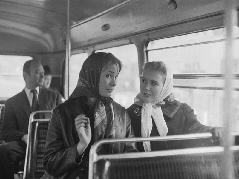 Actors Juliet Mills and Julia Lookwood on a double-decker bus in London in November 1960