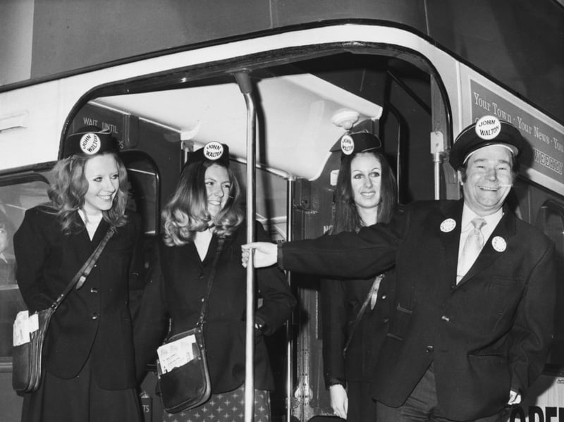 Actor Reg Varney, star of television show 'On the Buses', poses with three women 'clippies' on the deck of a bus in November 1971
