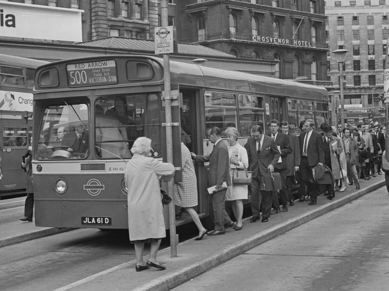 Passengers queue for a Red Arrow bus outside London's Victoria Station in August 1968