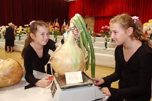 Makala and Chantelle Sleightholme were admiring the winning onion in the 2005 Sunderland Horticultural Show.