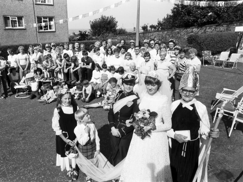 Residents of Coillesdene Grove, Joppa, get ready for their street party to celebrate the royal wedding in July 1981. Children and an elderly man are dressed up to portray Prince Charles, Princess Diana and the Archbishop of Canterbury.