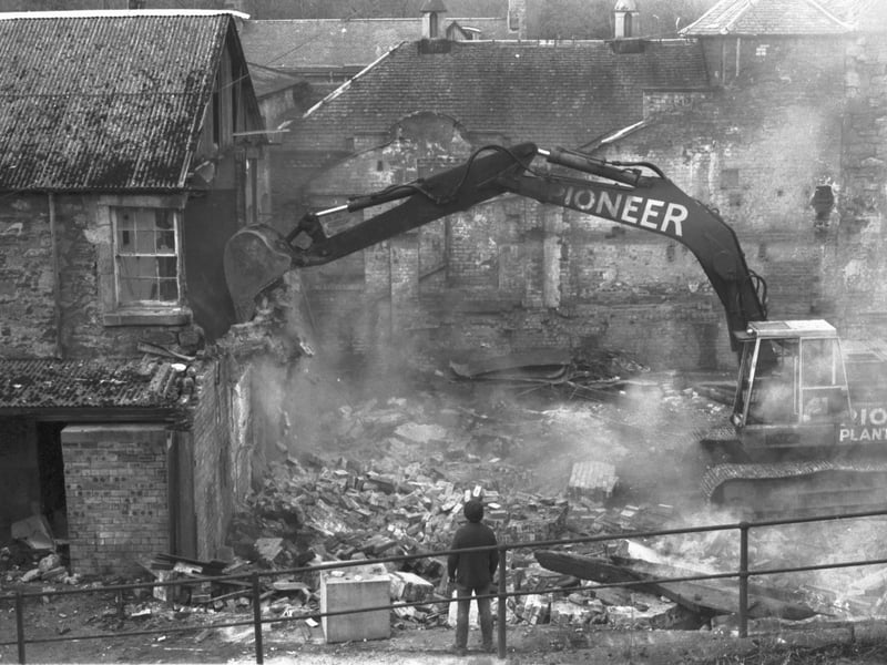 A wrecking machine rips off the wall of Polton Mill in Lasswade as it is demolished in March 1981