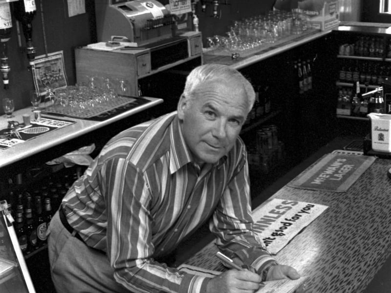 Lawrie Reilly, legendary Hibs football player (one of the Famous Five), behind the bar of his Leith pub, the Bowlers' Rest, in August 1985