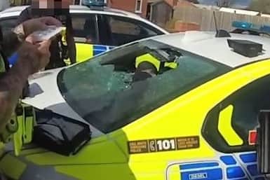 Police officer left with glass in back after car attacked