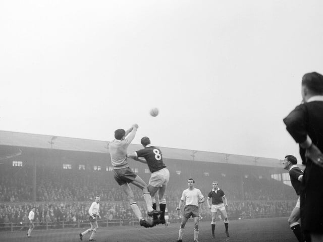 Roy Barry tackled by a Falkirk defender in a game between Falkirk and Hearts at Brockville in November 1964.