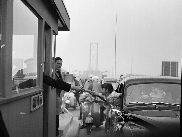 Donna Morrison of Broughty Ferry pays her 2/6 toll during the opening day of the Forth Road Bridge in September 1964.