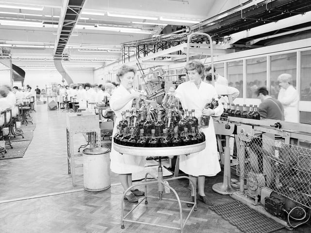 Women with bottles of Chivas whisky at the company's plant in Paisley in 1964.