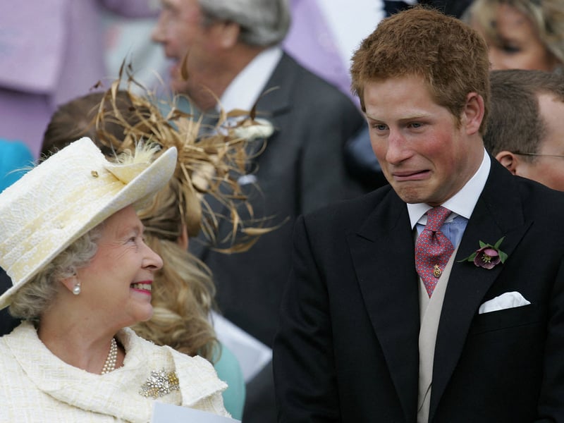 Queen Elizabeth II and Prince Harry share a joke as they watch Prince Charles and Camilla, Duchess of Cornwall, leave St George's Chapel in Windsor following their marriage blessing in April 2005.