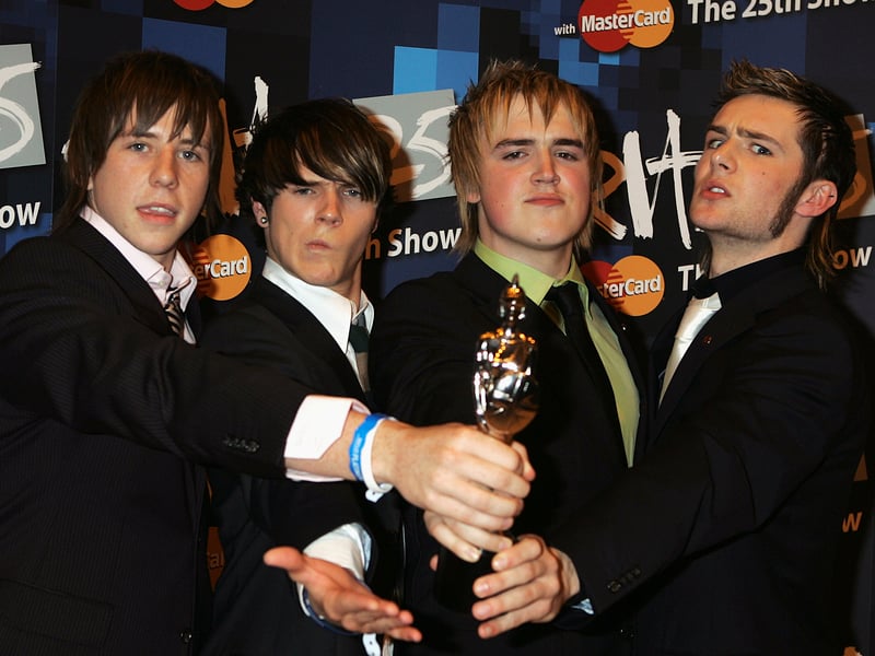 McFly pose with the award for Best Pop Act during the 25th Anniversary BRIT Awards 2005