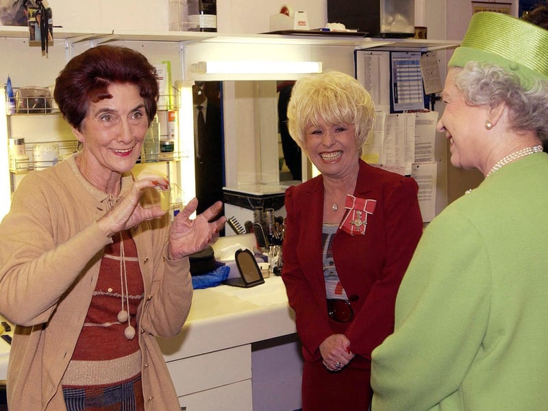 Queen Elizabeth II meets EastEnders actors June Brown (Dot Cotton) and Barbara Windsor (Peggy Mitchell) during a visit to Elstree Studios, where the soap is filmed, in November 2001