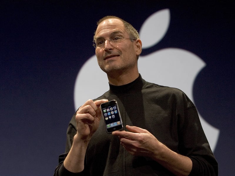 Apple CEO Steve Jobs holds up the new iPhone at its launch event in January 2007. The groundbreaking mobile phone went on sale later that that year.