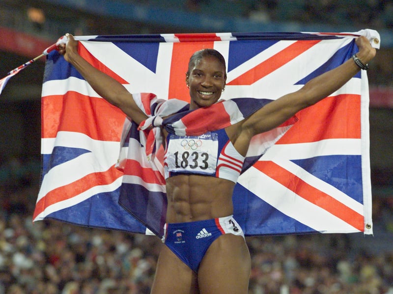 Great Britain's Denise Lewis poses after winning the heptathlon gold medal with 6,584 points at the 2000 Sydney Olympic Games