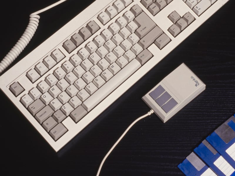 A computer keyboard, computer mouse, floppy disks and screen cleaner, pictured in around 2000